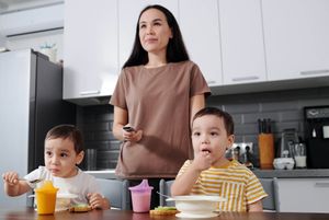 mom watches PBS with kids at lunchtime